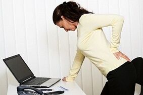 A woman has low back pain in the lumbar area